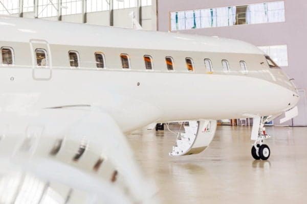 Side view of a Global Express aircraft with boarding stairs down.