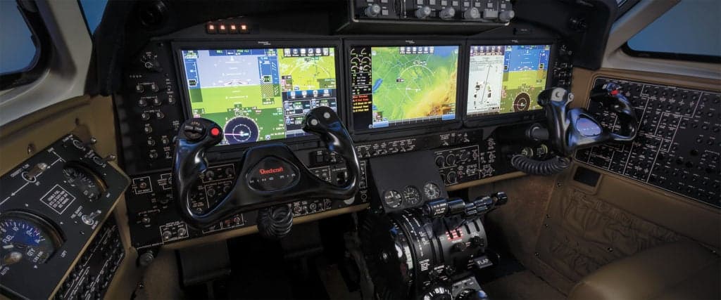 King Air 260 cockpit with three large display screens.