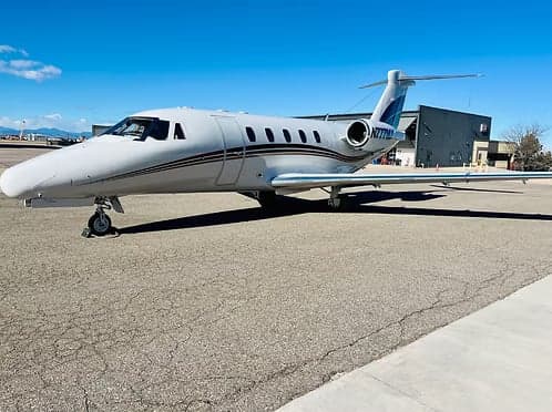 A white Cessna Citation sits on the tarmac with N777MX on the tail.