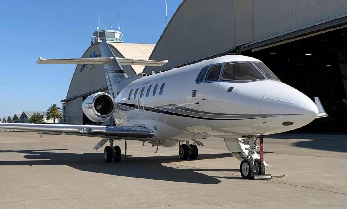 Hawker 800XP on the tarmac with a white and black paint scheme.