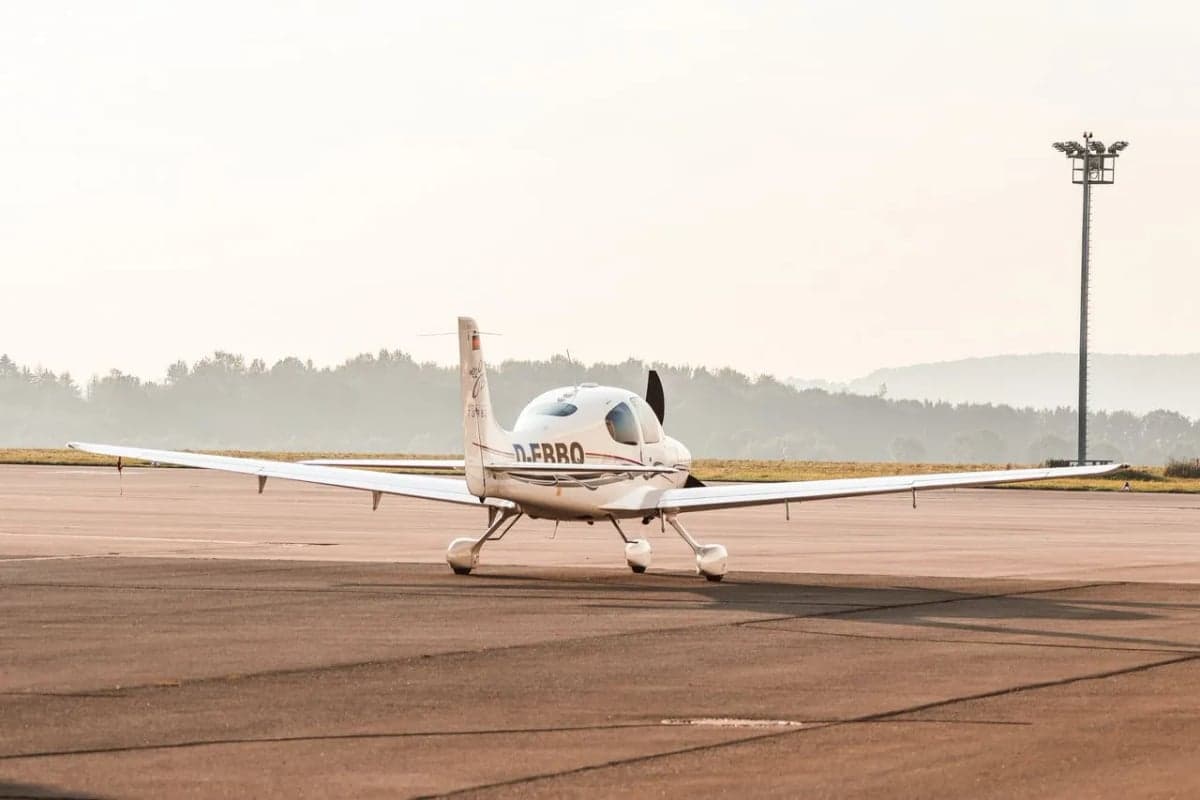 Front view of a Cirrus aircraft with registration D-EBBQ on the runway.