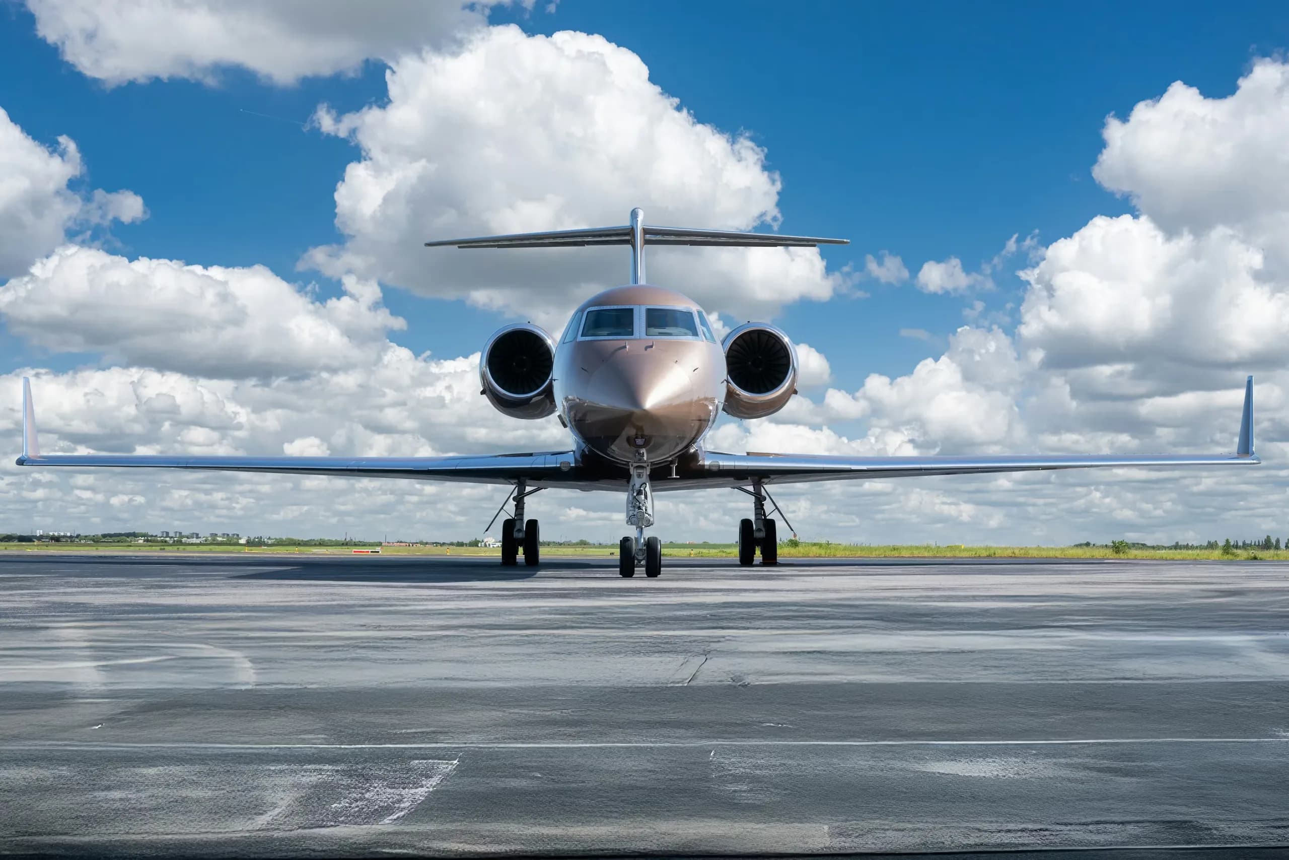 Front view of a bronze Gulfstream jet on the tarmac.