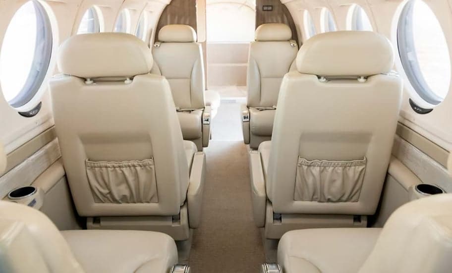 View down the aisle of the aircraft's interior with leather seats.