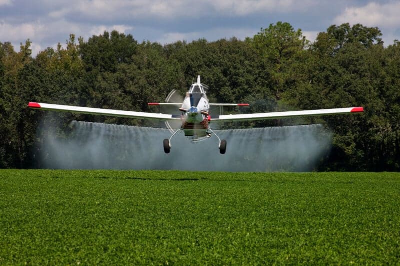 Air Tractor spraying crops in a field.