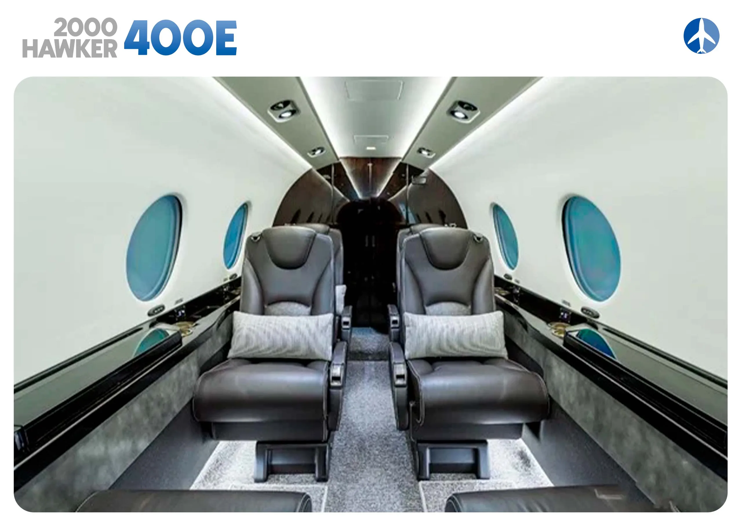 Hawker 400XP cabin interior with leather seats and pillows.