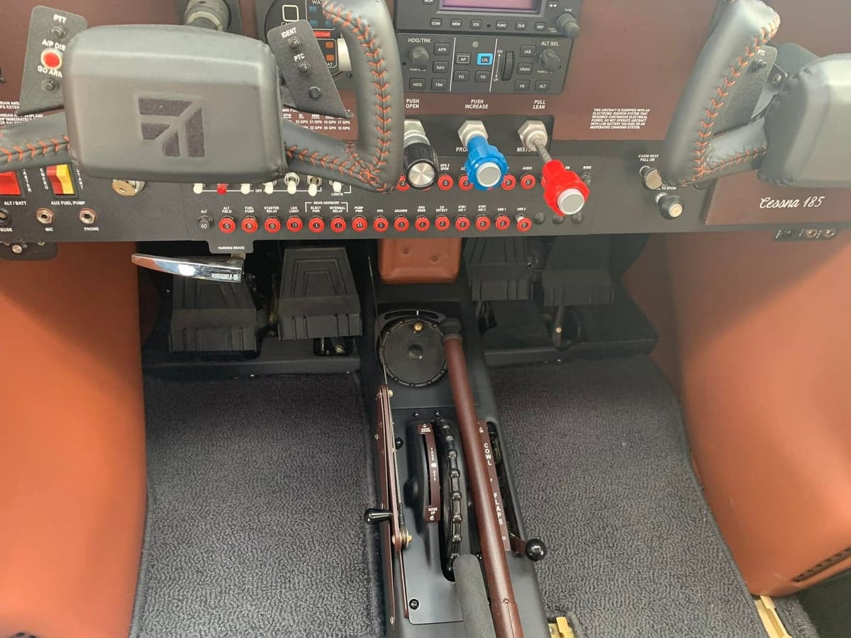 Close-up of the Cessna 185 cockpit controls and instrument panel.