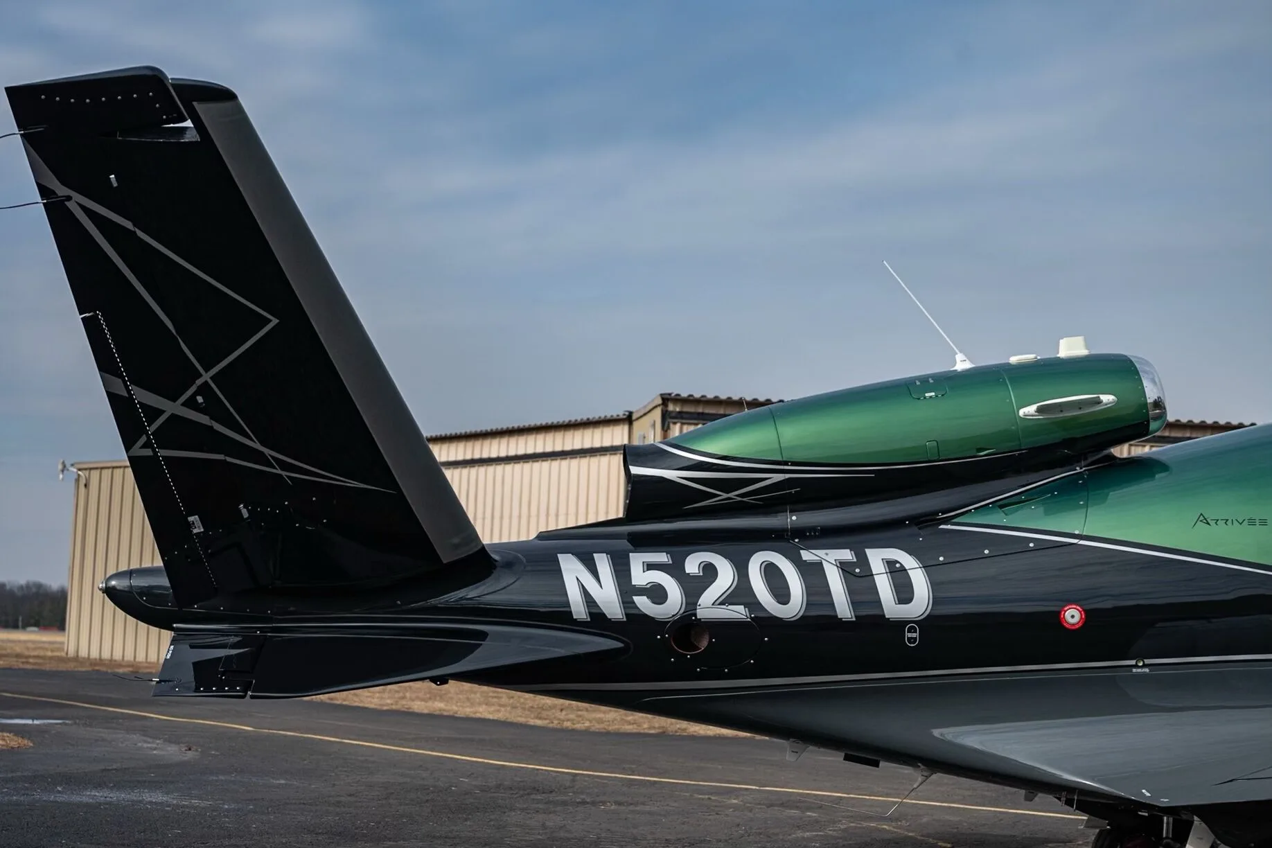 A close-up of the tail section of the Cirrus Vision Jet N520TD showing the registration number.