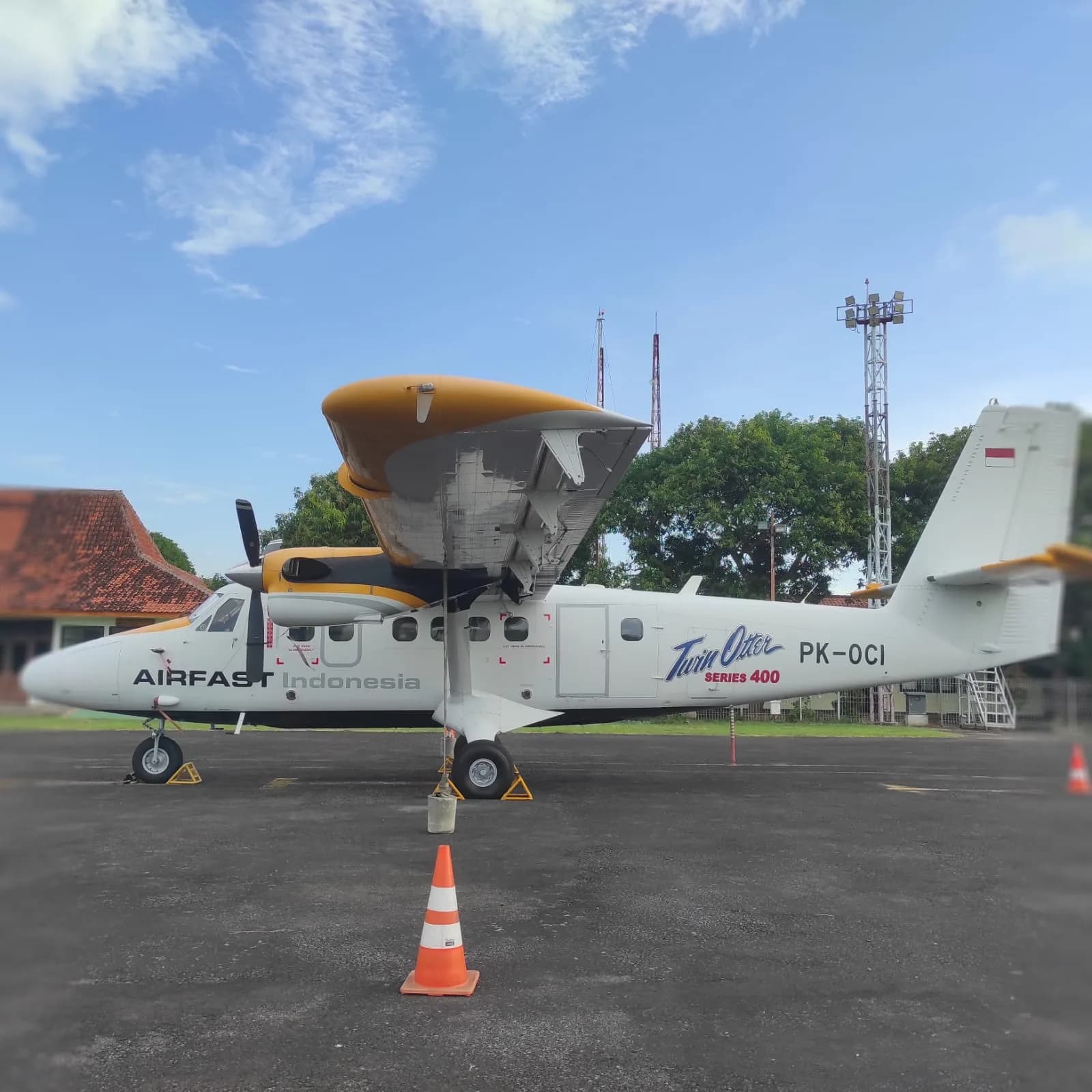 Side view of the PK-OCI Twin Otter Series 400 aircraft on the ground.