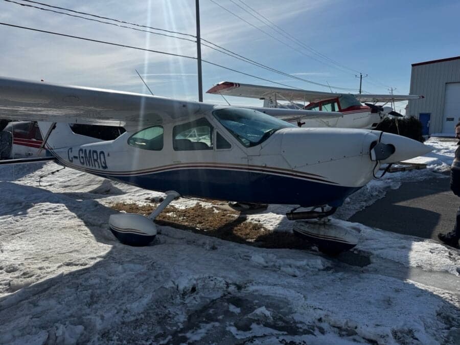A Cessna aircraft with registration C-GMRQ parked on the ground in winter.