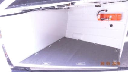 The cargo area of the helicopter with a fire extinguisher.