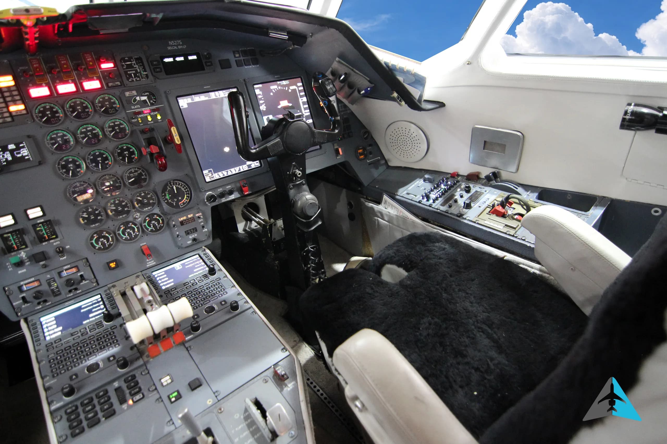 A view of the right side of a business jet cockpit, showing the instrument panel and controls.