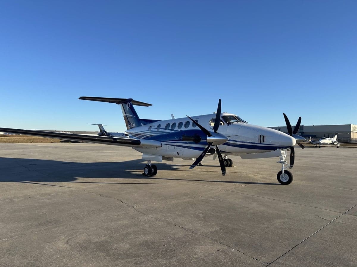 Front quarter view of a blue and white King Air 360 on the tarmac.