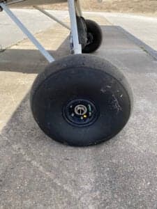 Close-up of the large tire on a Piper Cub aircraft.