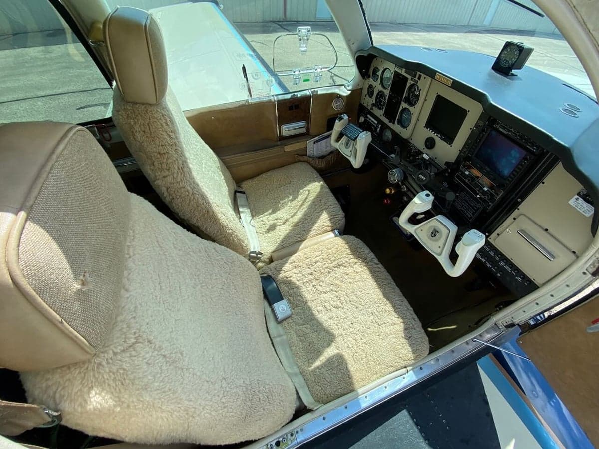 View of the aircraft's cockpit and sheepskin seat covers.