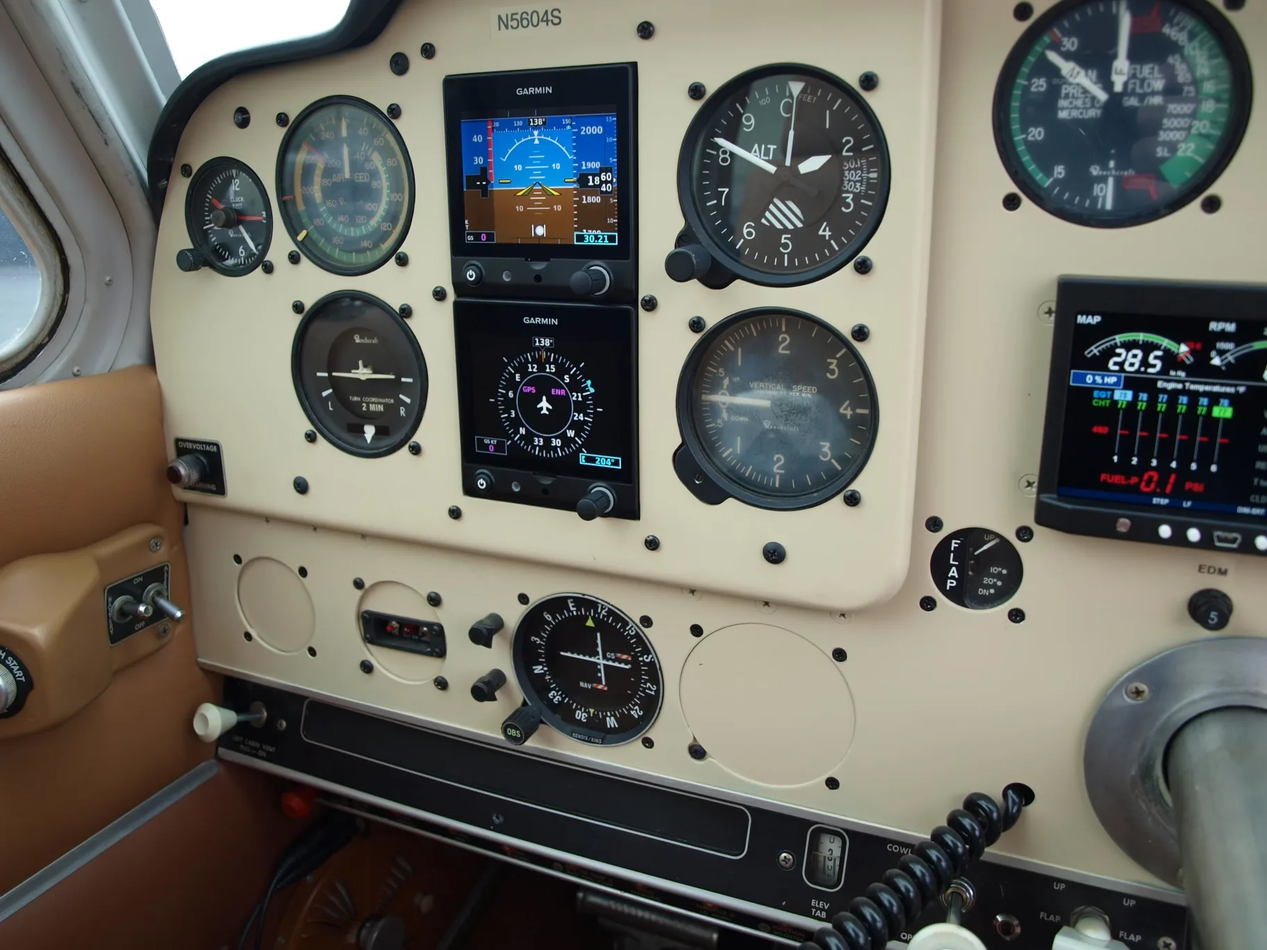Close-up of the instrument panel in the cockpit of a Beechcraft V35 Bonanza aircraft.