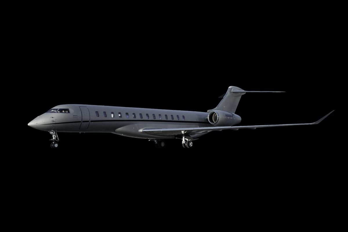 N988DX Bombardier aircraft isolated on a black background.