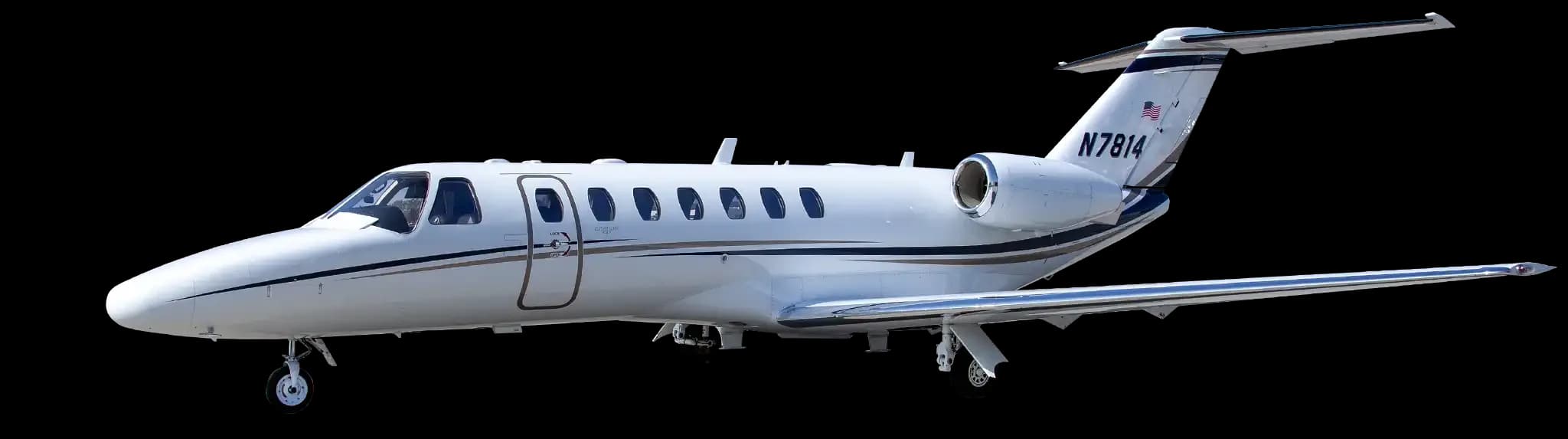A white Cessna Citation business jet with registration N7814 on the tail, viewed from the front-right on a clear day.