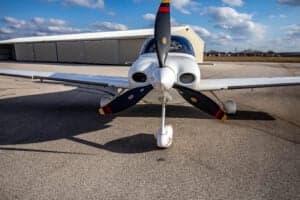 Front view of a Cirrus SR22 aircraft with a custom paint scheme on the tarmac.