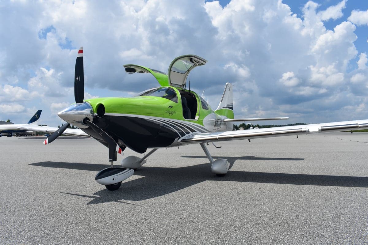 Front view of a green and black Cessna TTX on the tarmac.