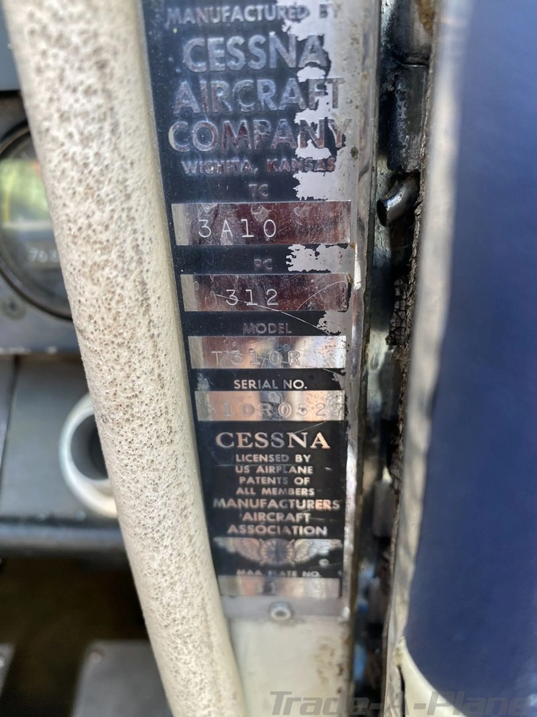 A close-up of the Cessna aircraft manufacturer's data plate, showing model T310R and serial number.
