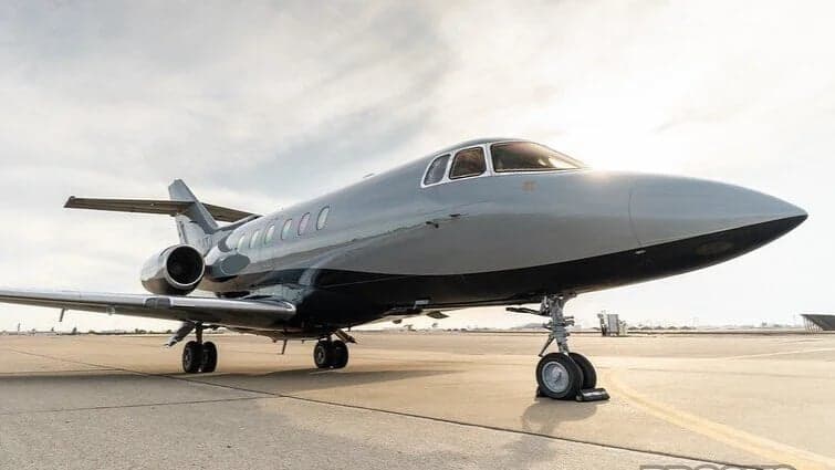 Hawker 800XP on the tarmac with a gray and black paint scheme.