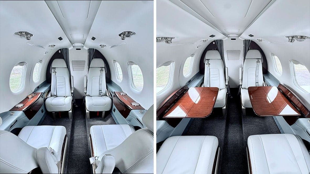 Interior cabin view of N6422Z Phenom 300E with seats and tables.