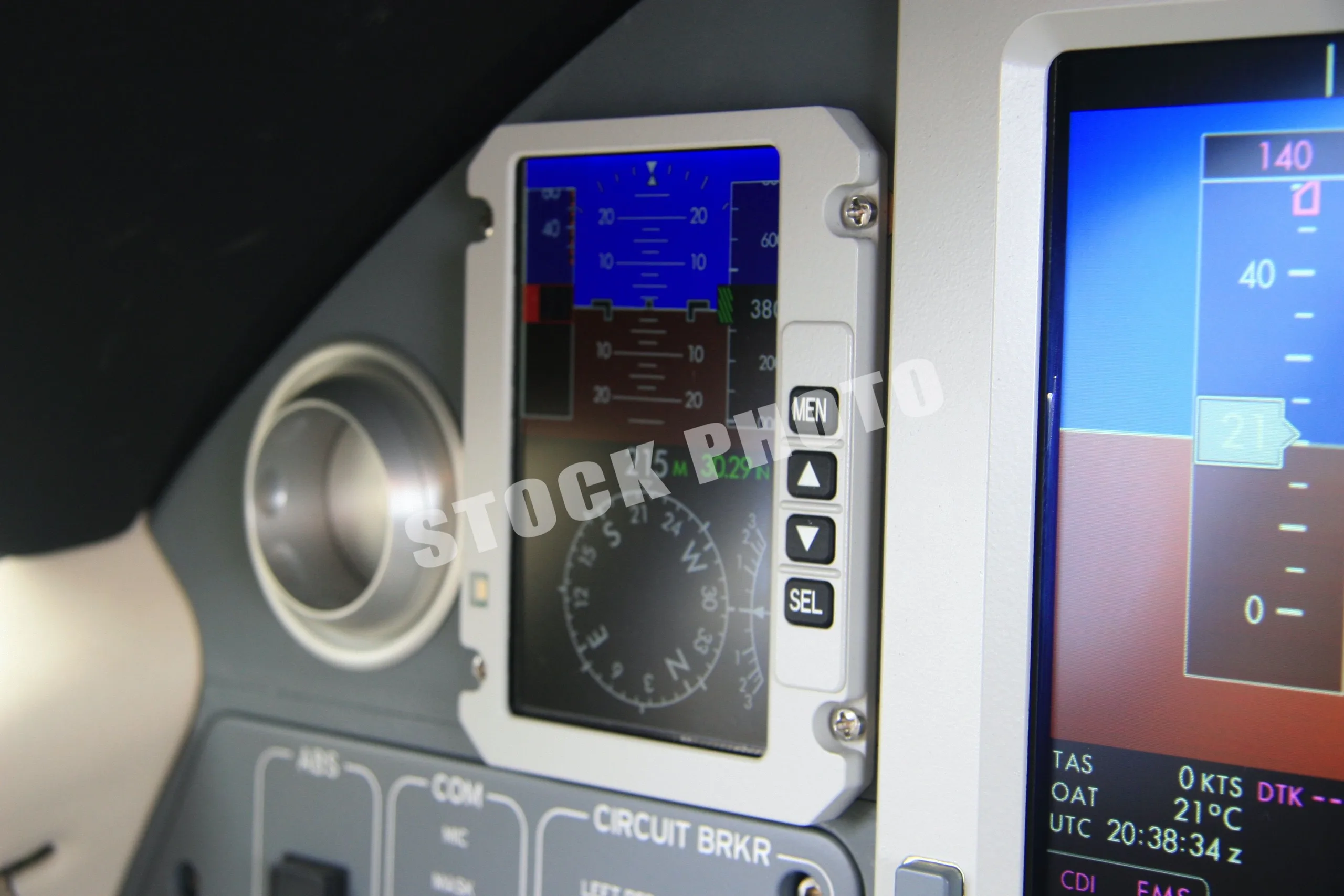 A close-up of a small digital display with menu buttons in the Eclipse 500 cockpit.