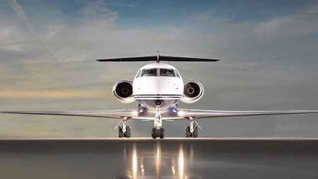 Front view of a private jet on the tarmac.