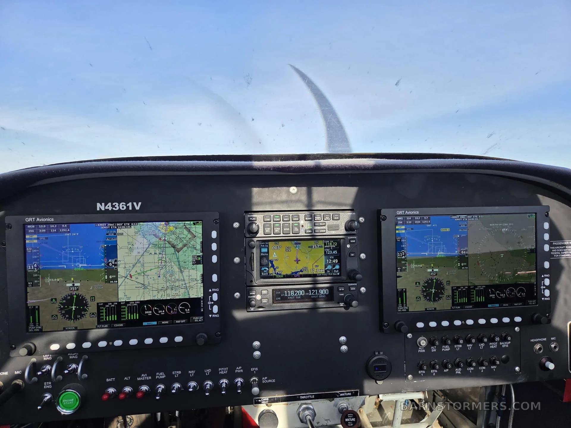 A view of the cockpit of an N4361V aircraft with two large digital displays and a central radio stack.