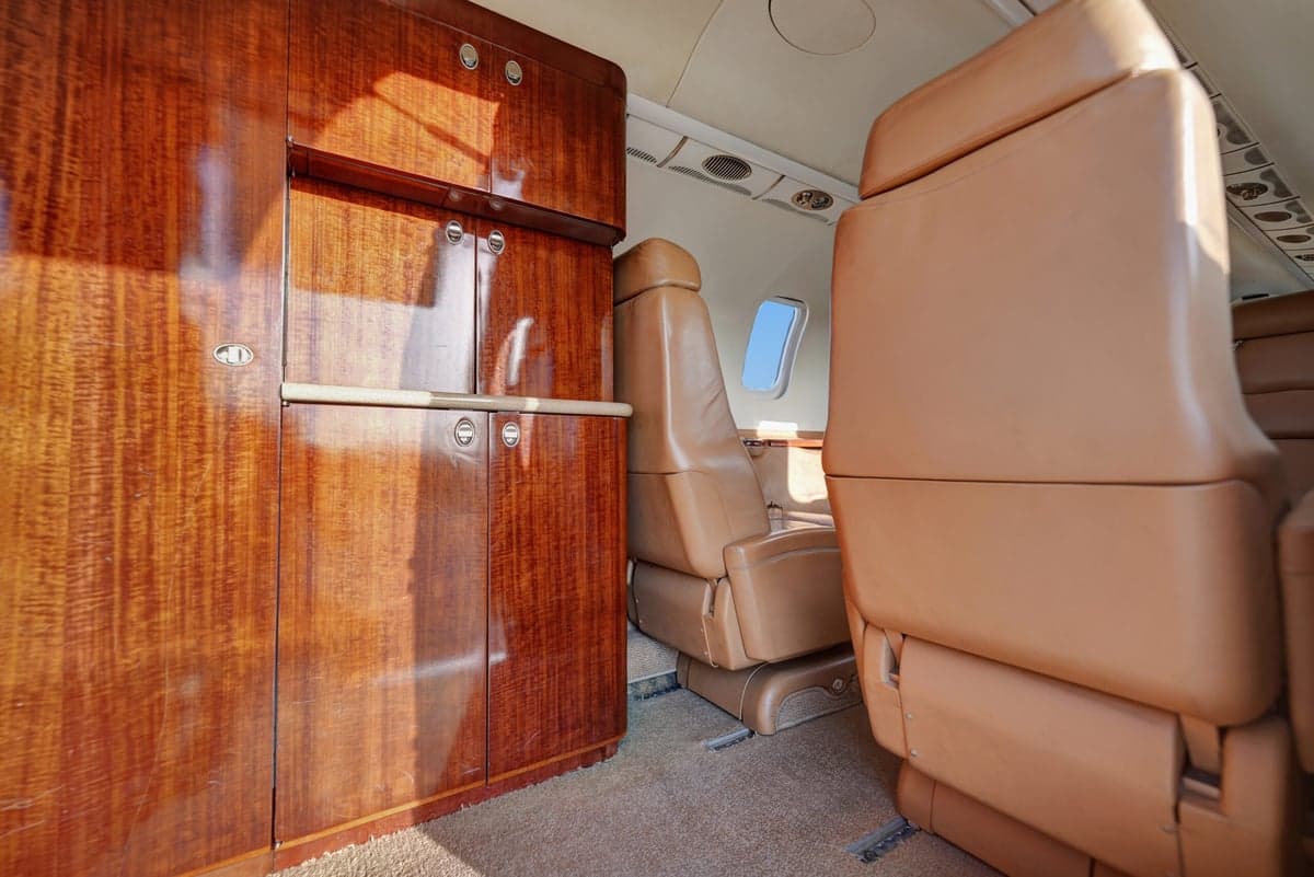 View of the aircraft cabin with tan leather seats.