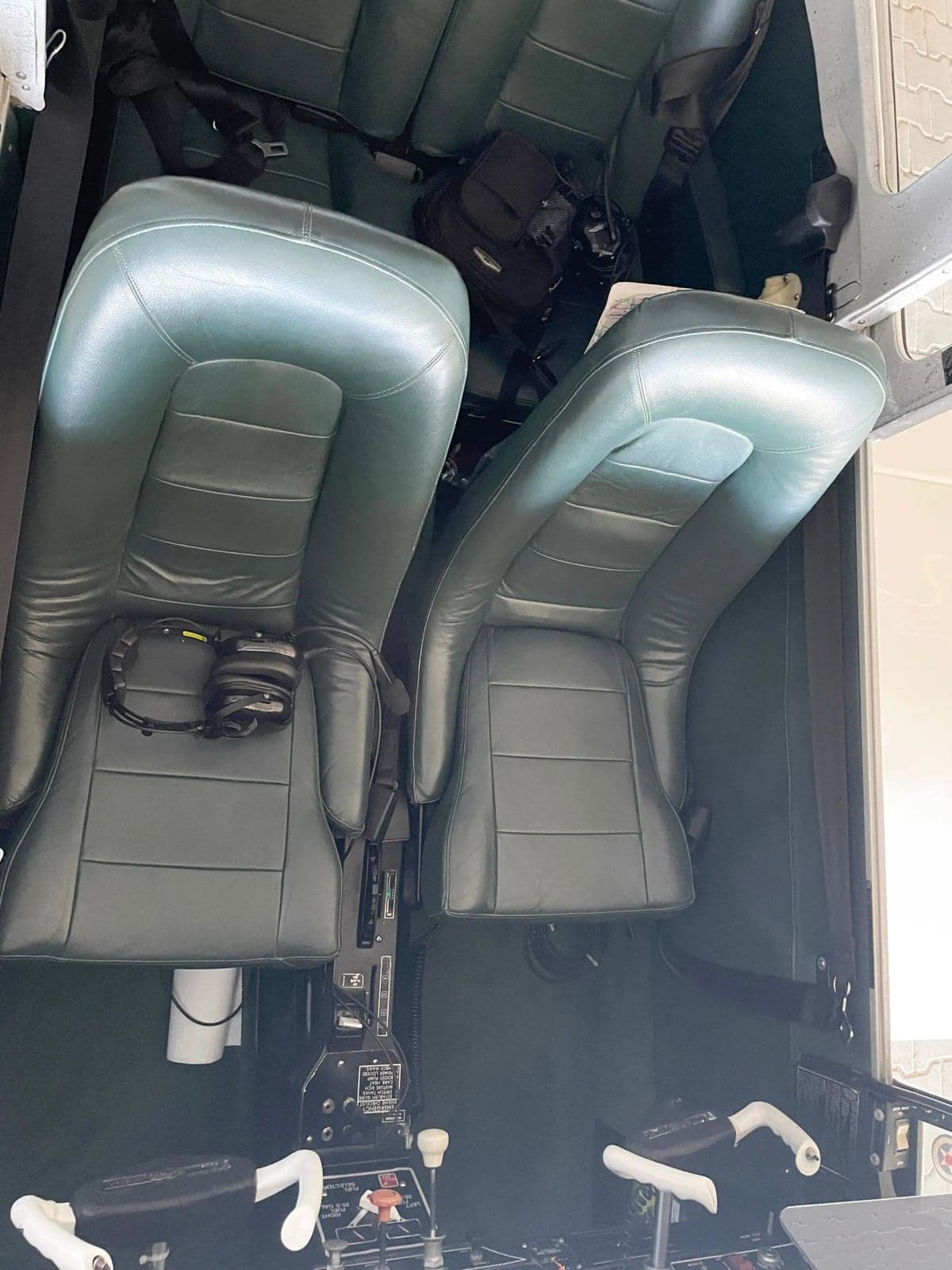 Interior view of the aircraft cabin with green leather seats.