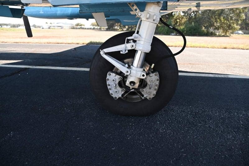Close up of the landing gear and wheel of a Beechcraft King Air.