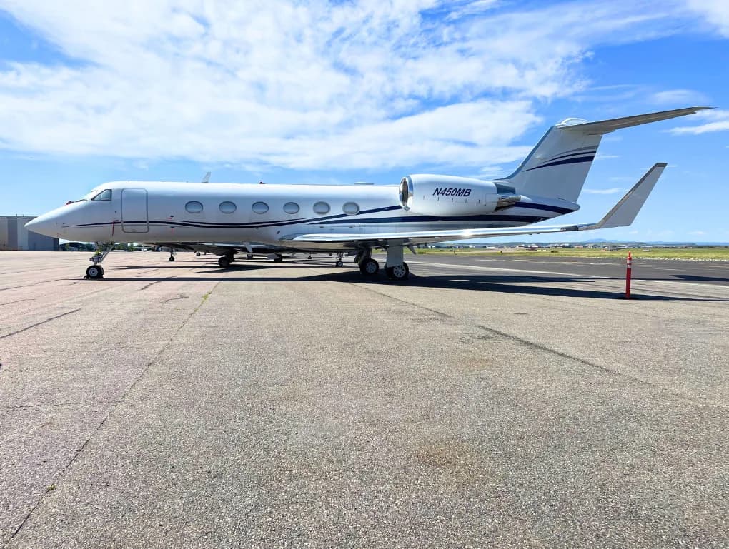 Gulfstream jet with blue accents parked on the tarmac.