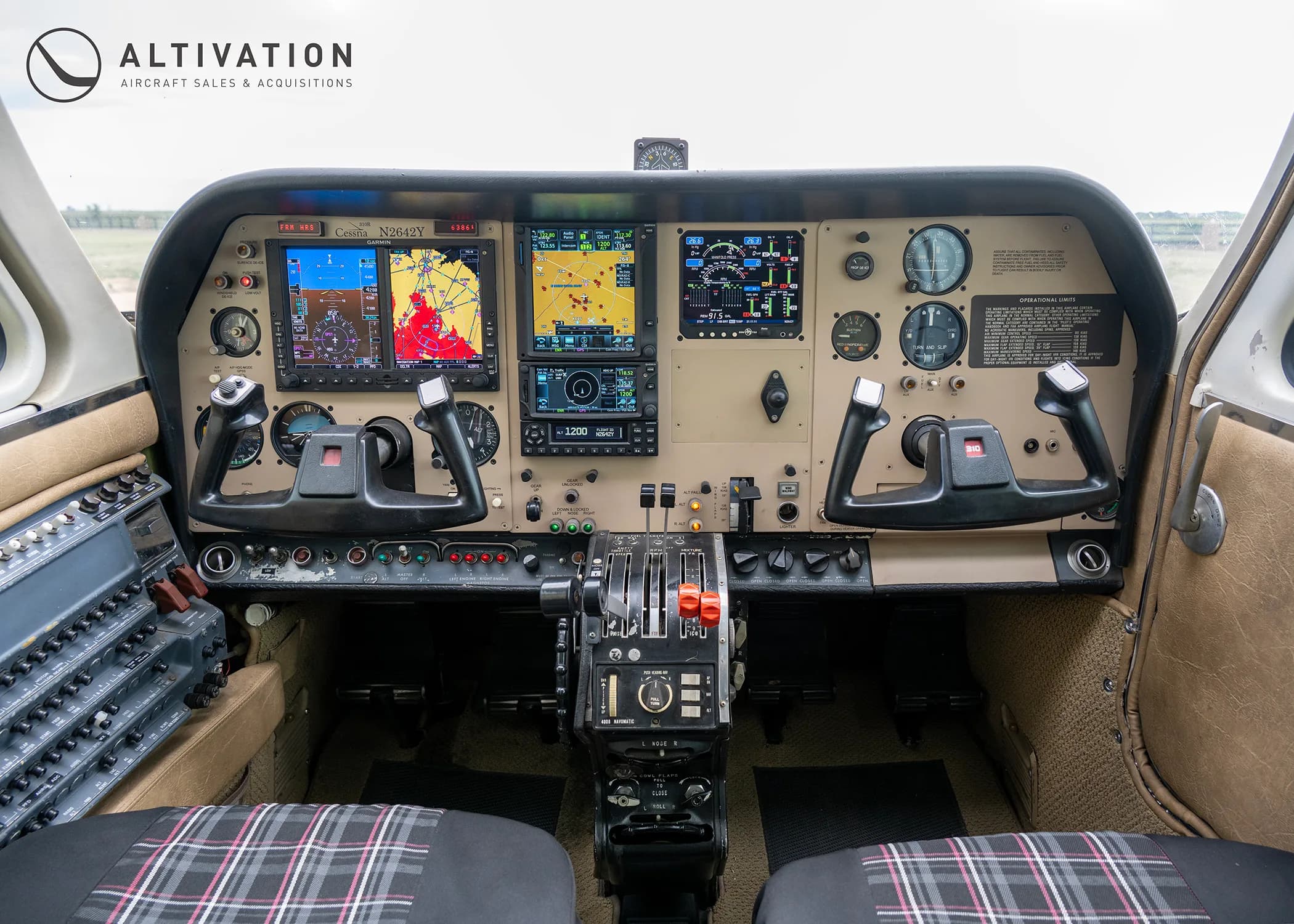 The cockpit of a Cessna N2642Y aircraft, featuring modern glass displays alongside traditional gauges and two control yokes.
