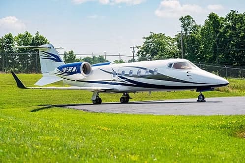 A Learjet 45XR, registration N156DH, parked on the tarmac.