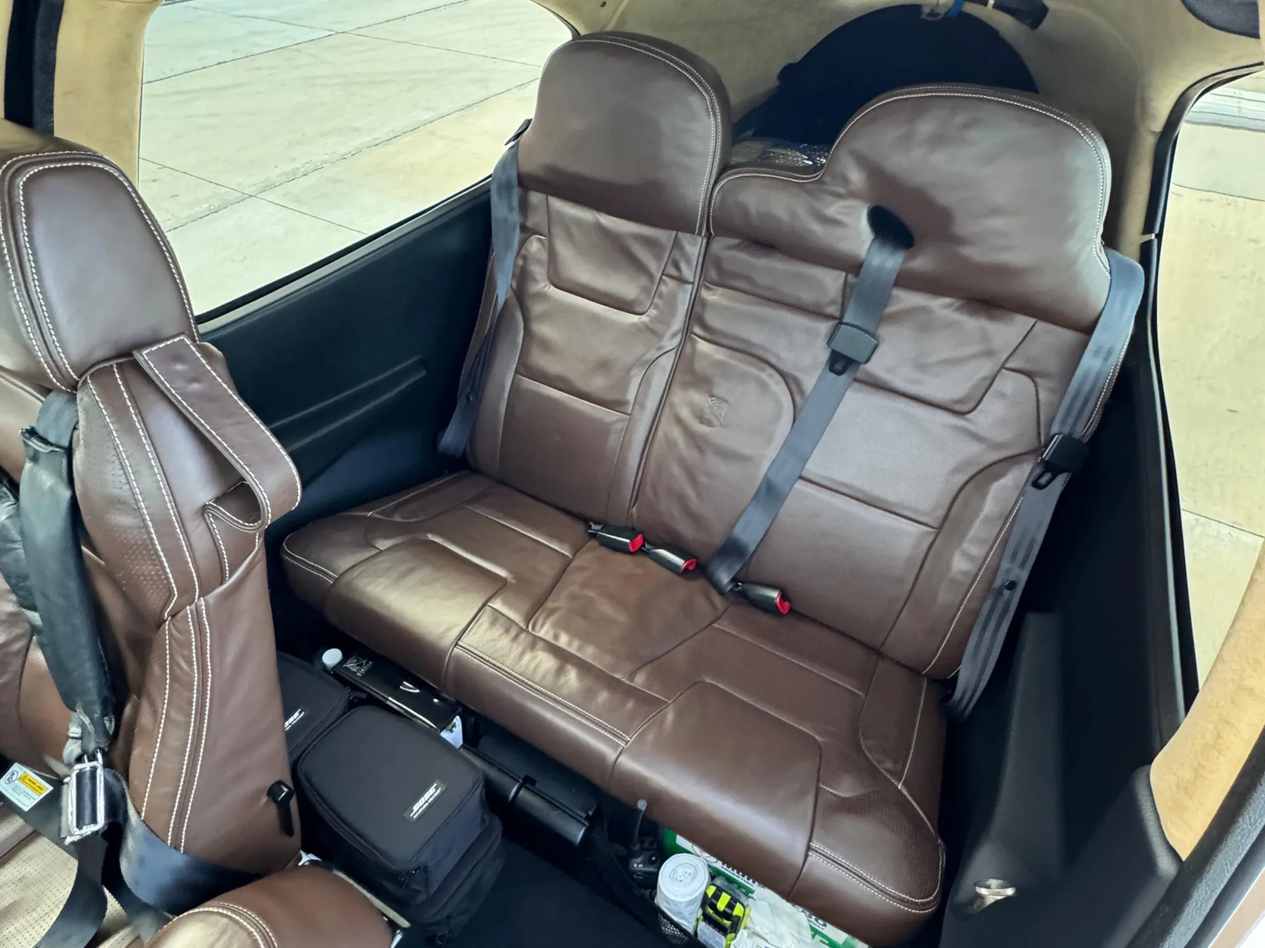 A view of the brown leather interior seats and cabin of a Cirrus SR22T aircraft.