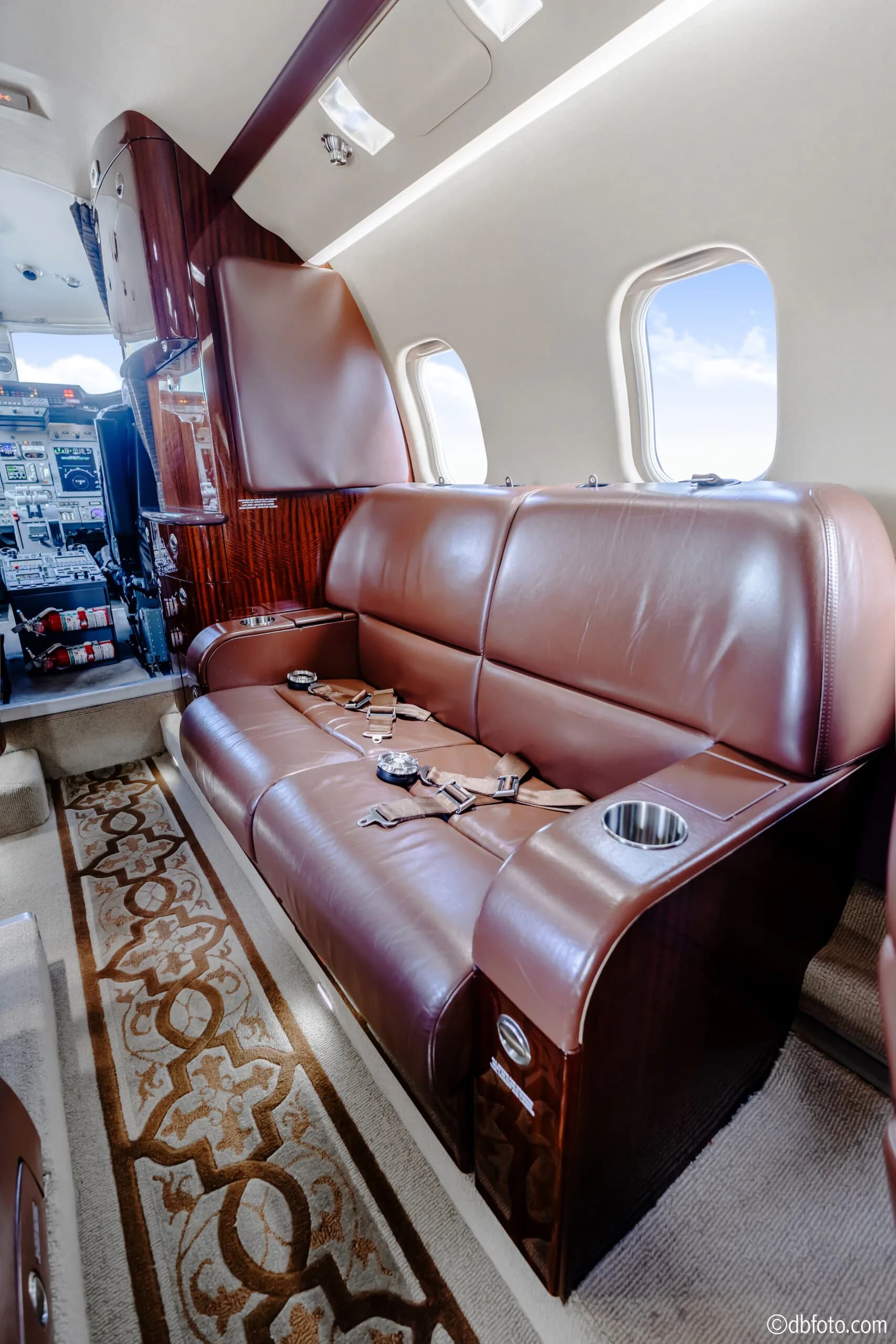 View of the Learjet 45XR cabin with leather seats and a couch.