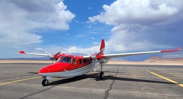 A red and white Partenavia P.68 on the tarmac.