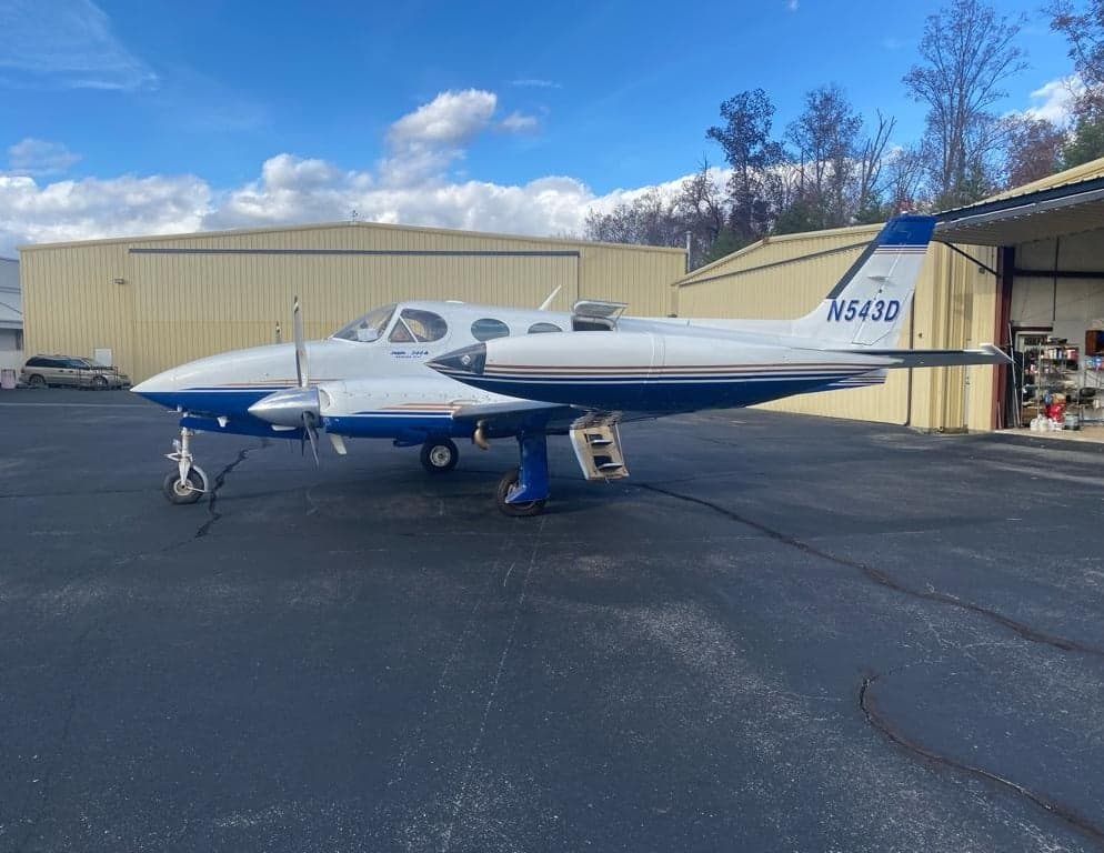 Side view of the Twin Cessna aircraft, registration N543D, parked on the tarmac.