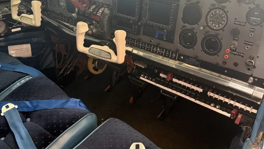 View of the aircraft cockpit and cabin seats.