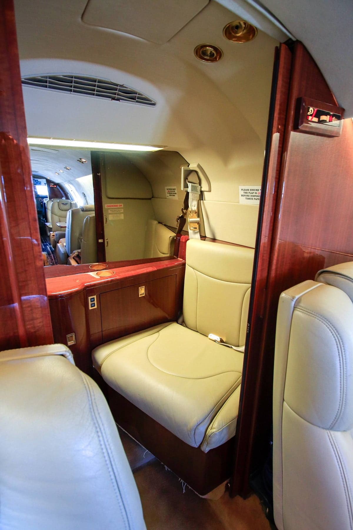 View of the Beechjet 400A cabin with tan leather seats and wood trim.