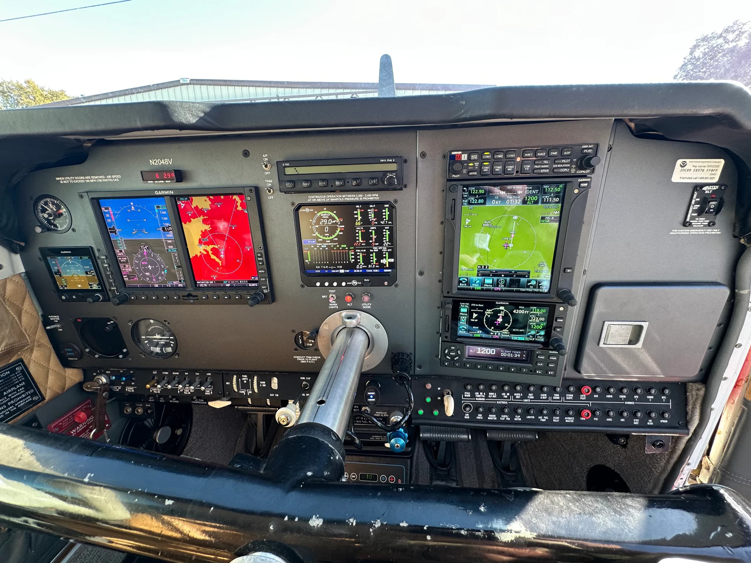 The instrument panel of an aircraft cockpit features multiple displays and controls.