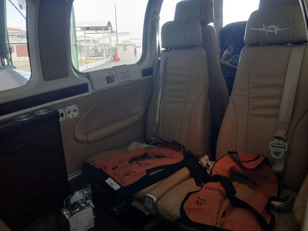 View of the rear seats in the cabin with life vests.
