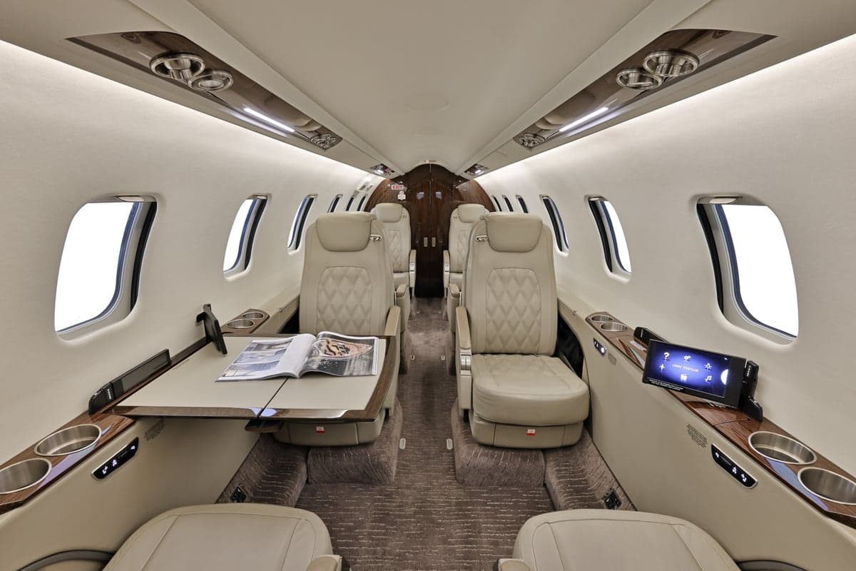 View of the Learjet 45XR cabin with seating and tables.