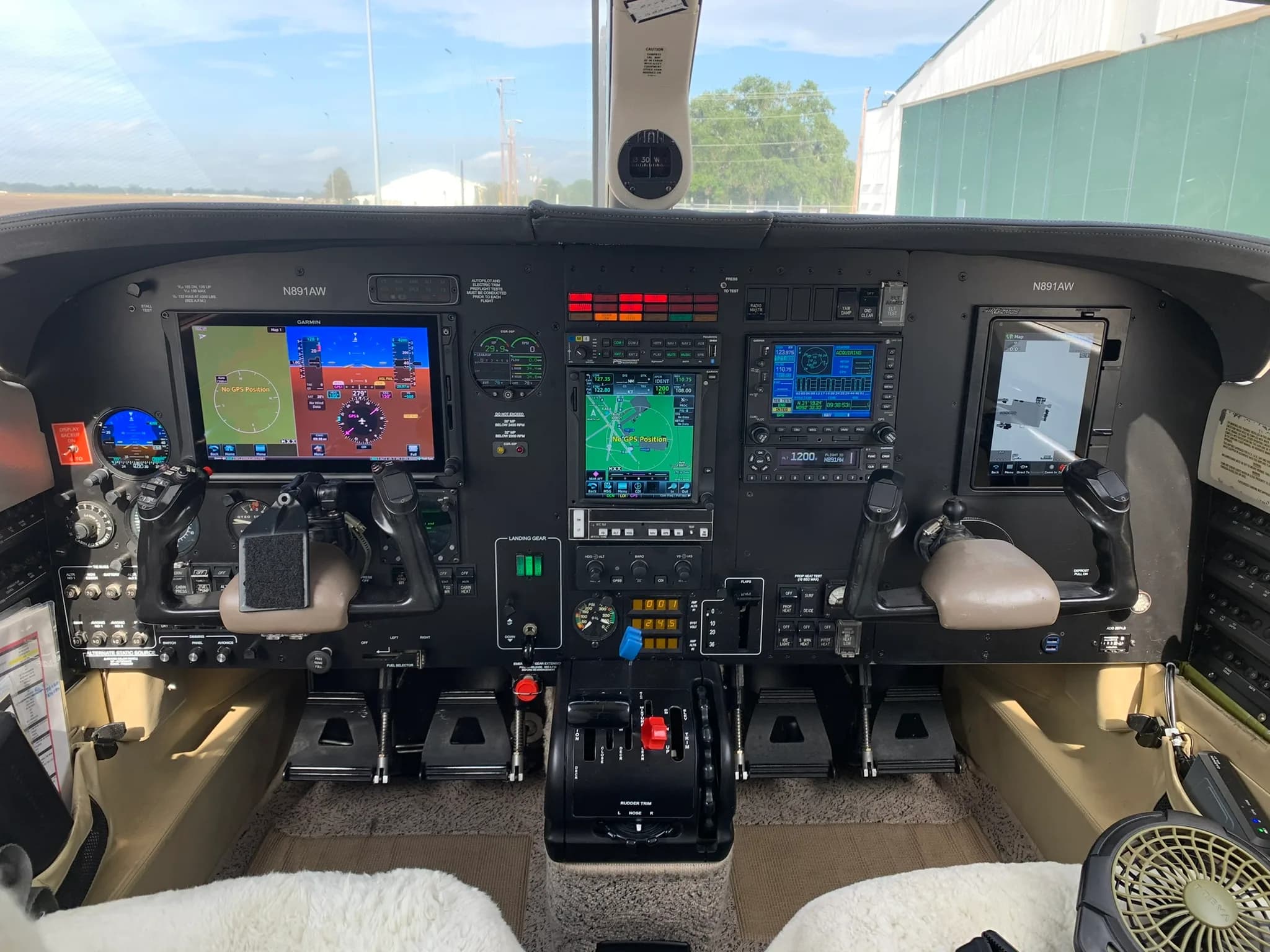 The cockpit of the Piper Mirage aircraft, featuring multiple digital displays, analog gauges, and controls.