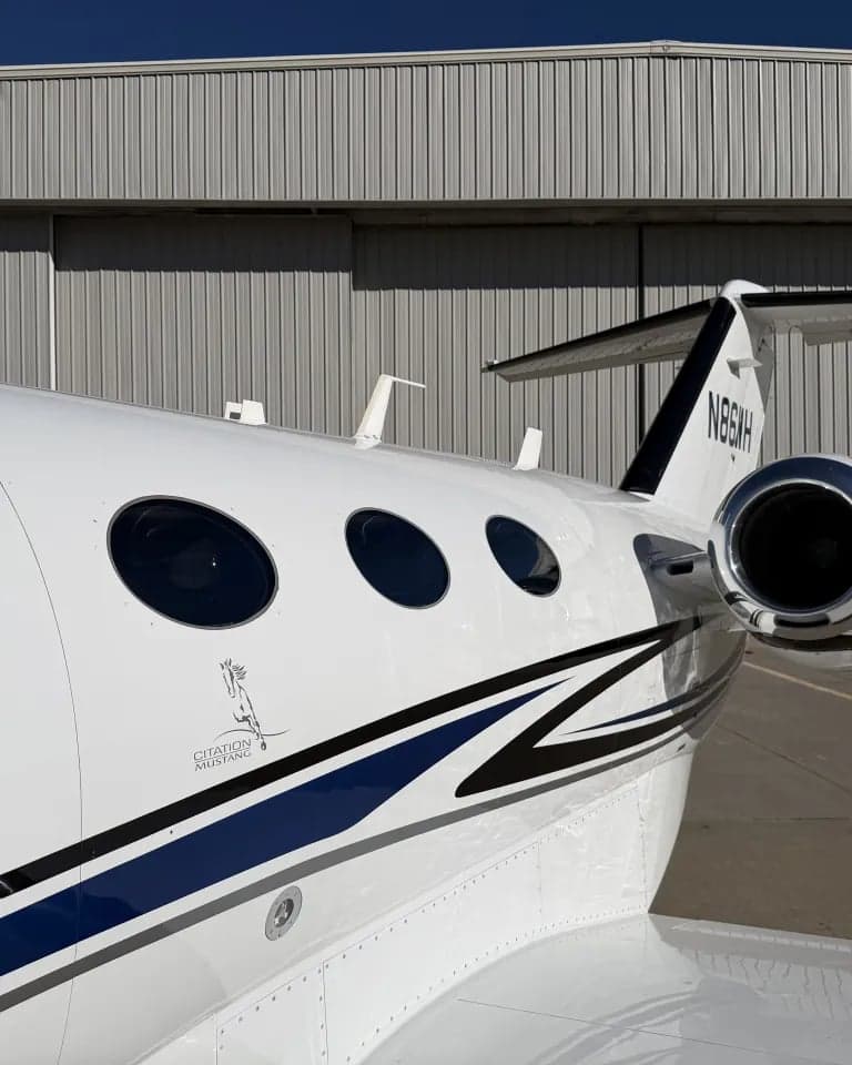 Close-up of the tail section of a Citation Mustang, showing the logo and tail number.