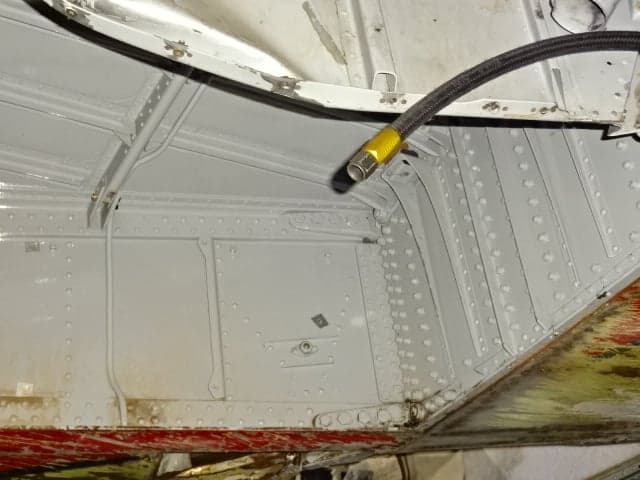 Close-up of the aircraft's internal structure with visible tubing and rivets.
