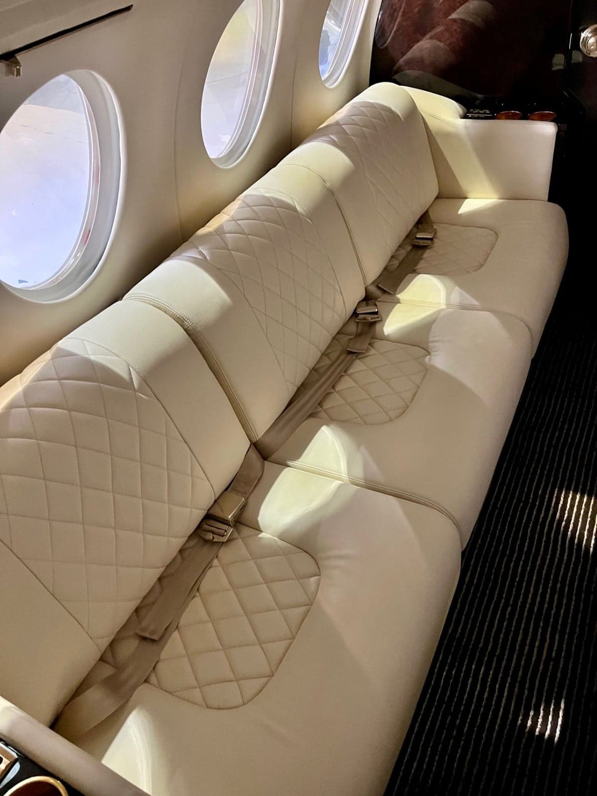 The interior of a Dassault Falcon 900 features a refreshment center with marble countertop.