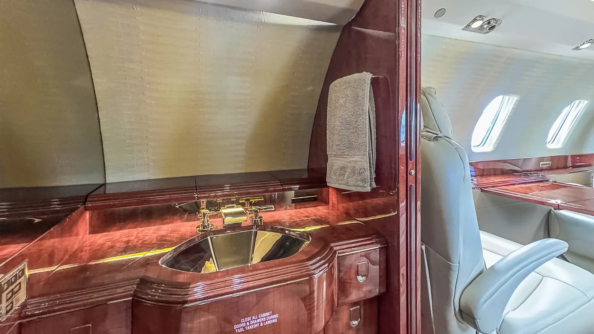Close-up of the aircraft's lavatory sink and seating area.