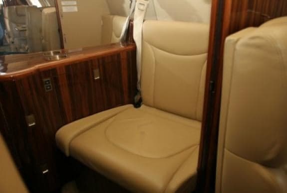 Close-up of a tan leather seat in the aircraft cabin.